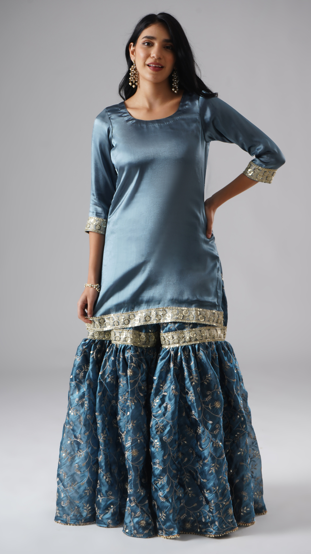 Front view of model wearing Zahrat’s Tehzeeb-e-Aab teal blue gharara set, showcasing the gharara and kurta without the dupatta.