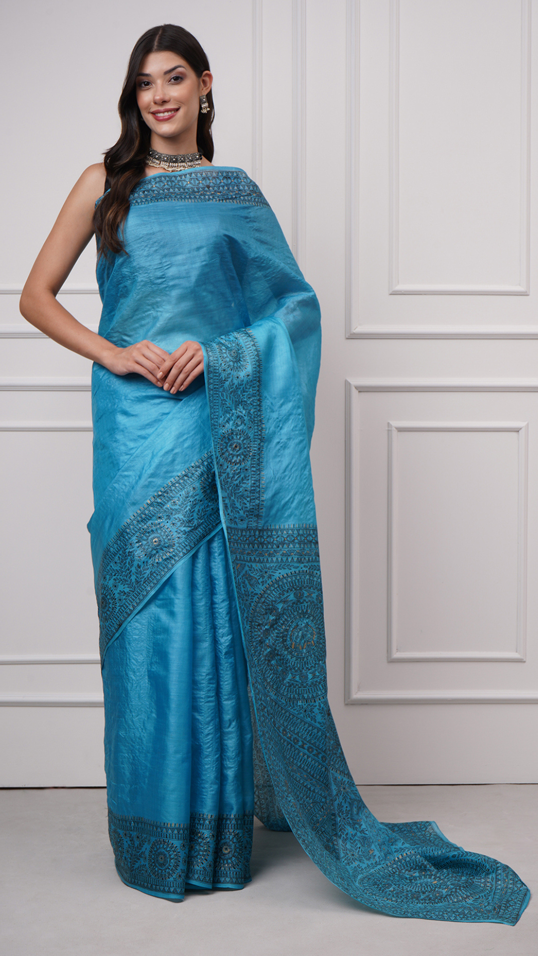 Model wearing Neelambara – Azure Madhubani Silk Saree by Zahrat with an elegant front drape showcasing hand-painted fish and geometric motifs.