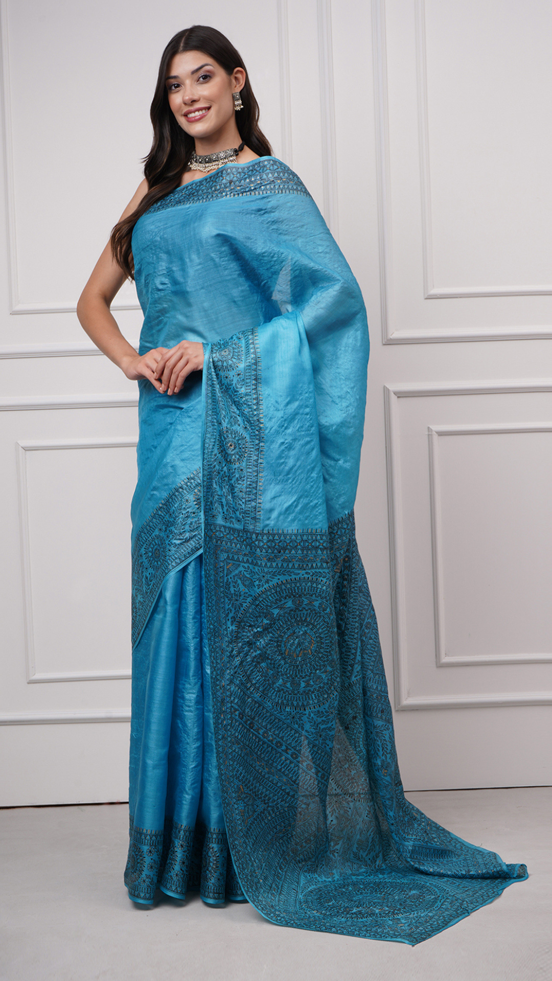 Left side view of Neelambara – Azure Madhubani Silk Saree by Zahrat highlighting the richly detailed Madhubani pallu and broad hand-painted border.