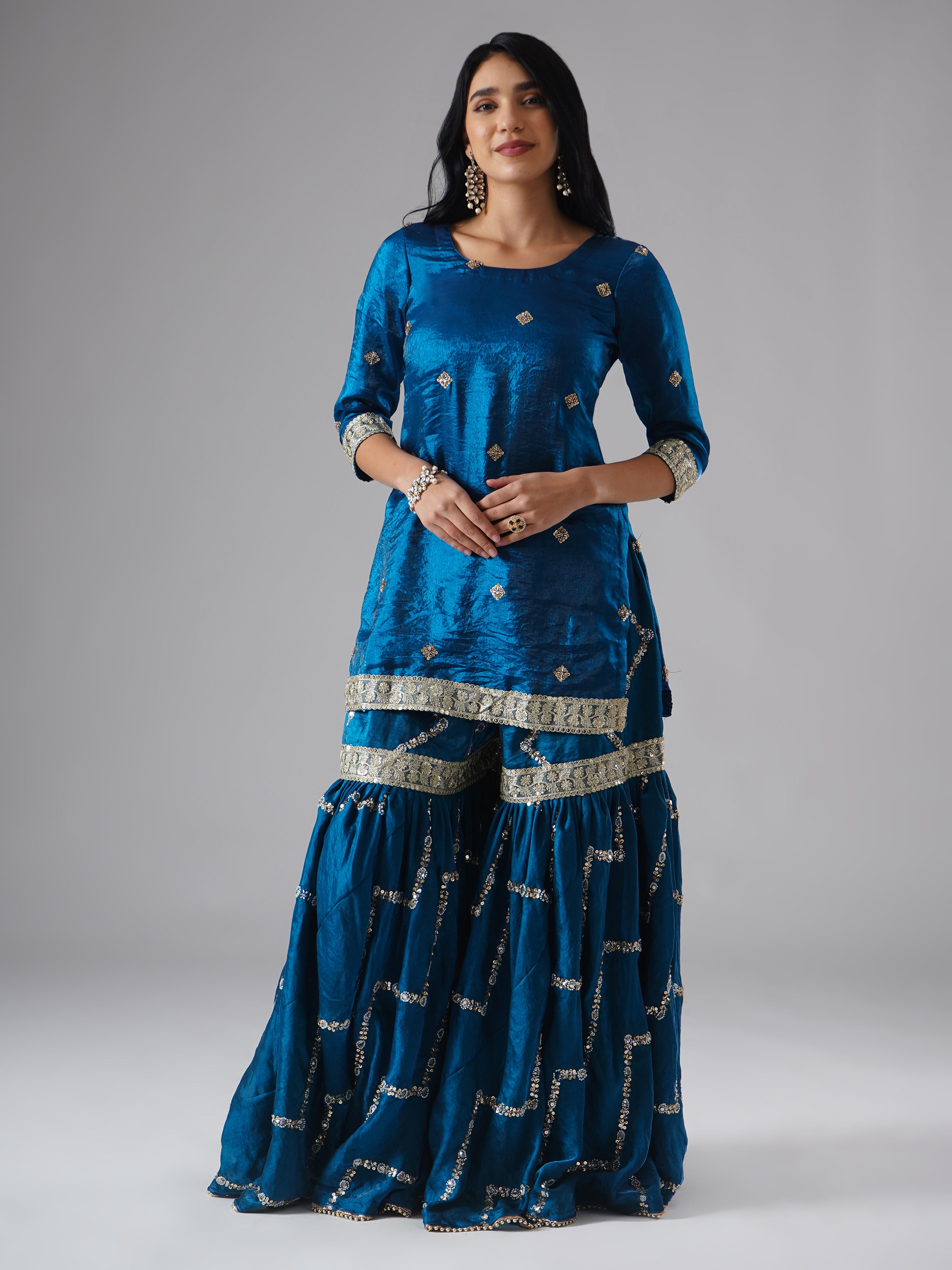 Model styled in the Neelafshan – The Teal Sapphire gharara set by Zahrat, front view highlighting the gharara and kurta without dupatta.