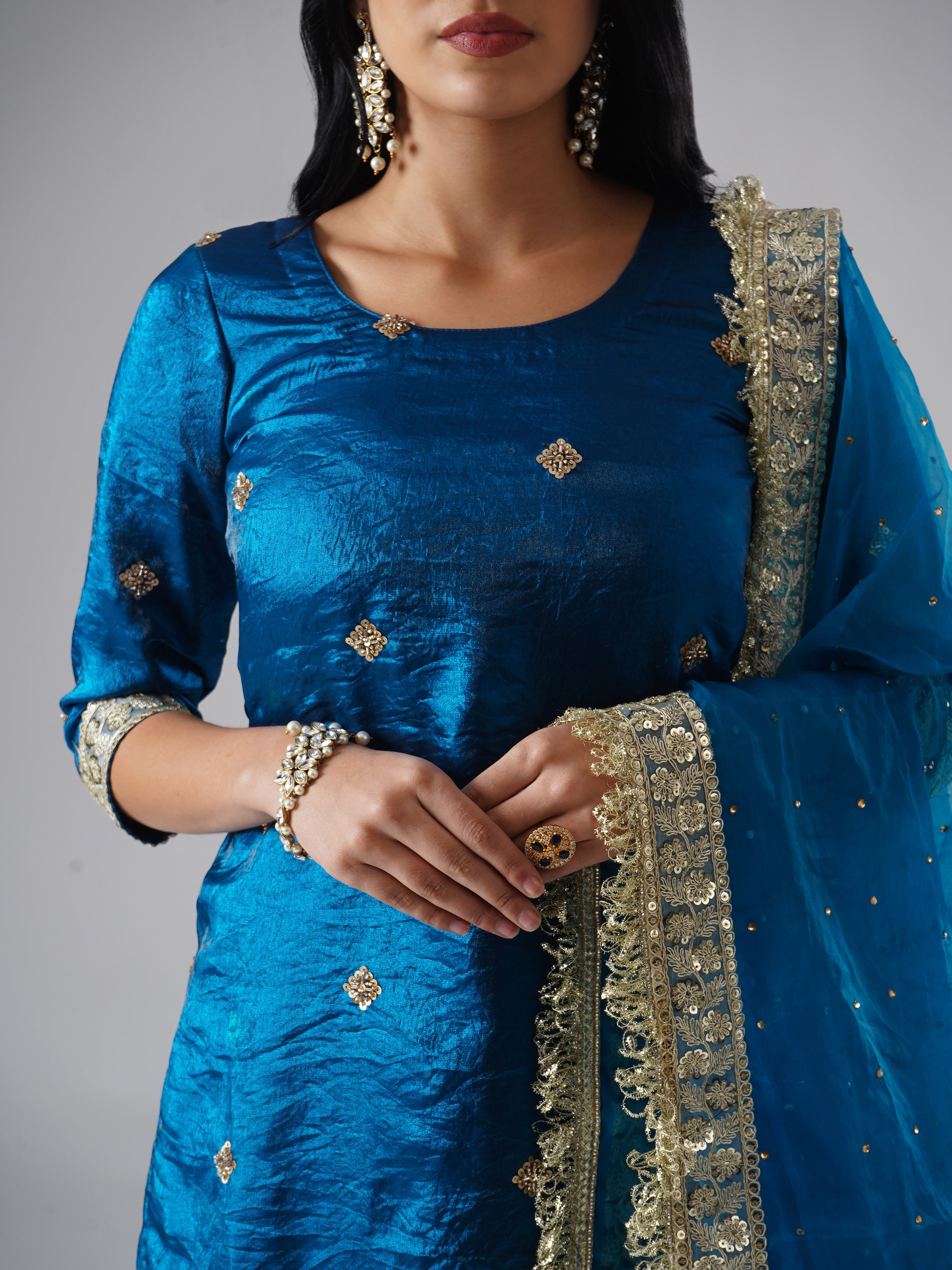 Close-up of Zahrat’s Neelafshan – The Teal Sapphire gharara set, highlighting the kurta fabric texture and dupatta design details.