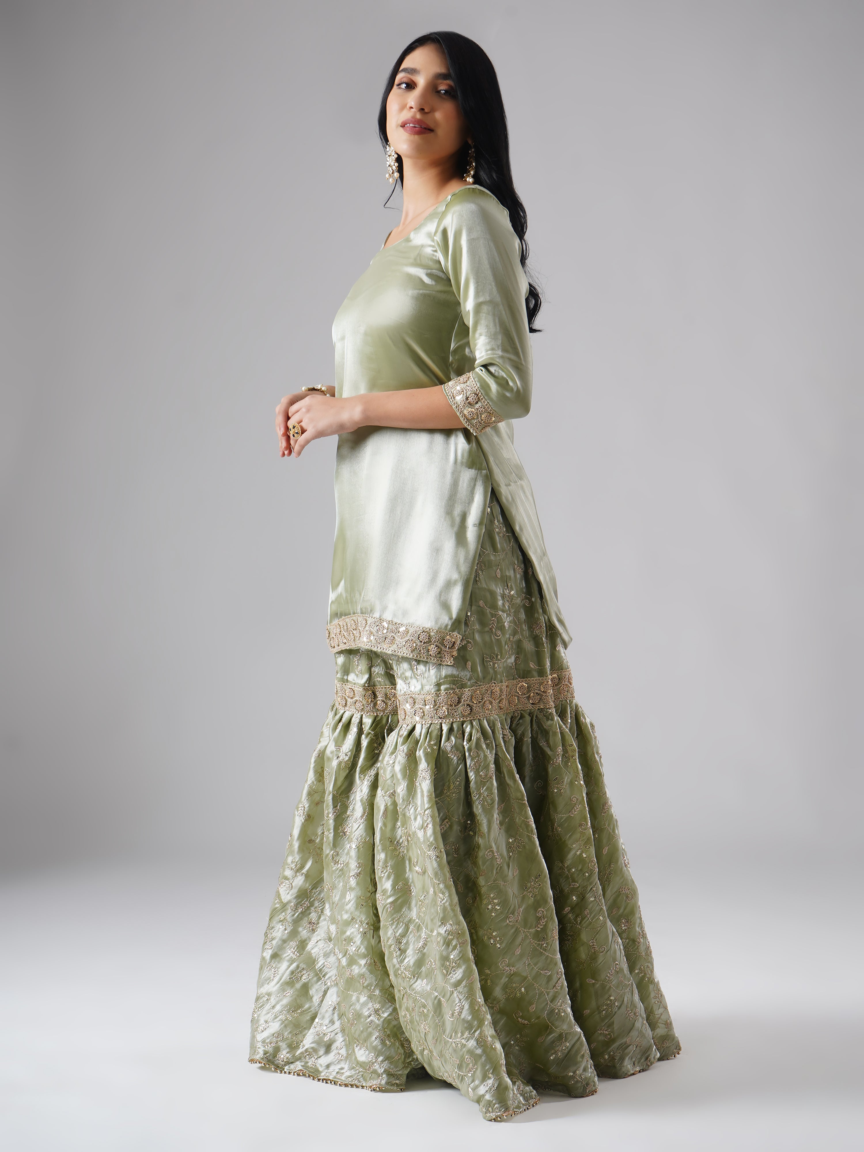 Side view of model wearing Zahrat’s Mehr-e-Zaytuni – The Olive Whisper gharara set without dupatta, highlighting the gharara flare and kurta.