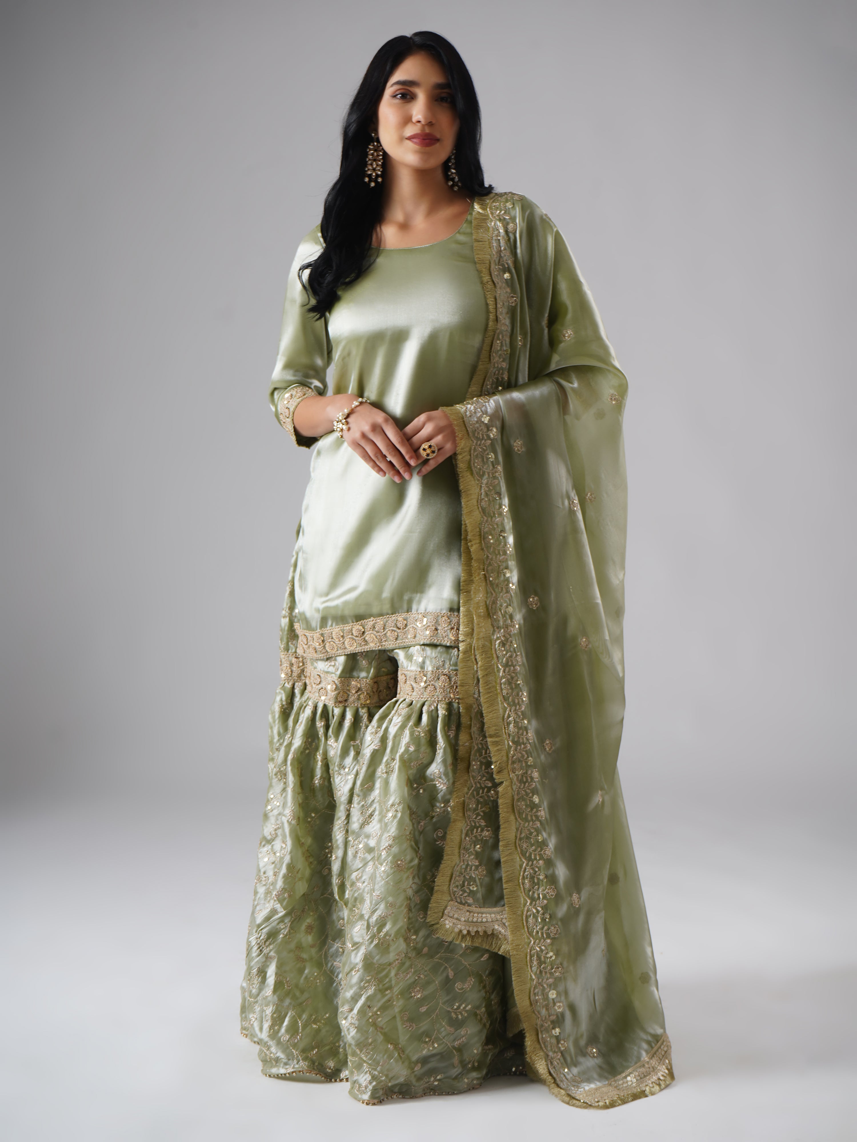 Model styled in the Mehr-e-Zaytuni – The Olive Whisper gharara set by Zahrat, front view highlighting the full outfit including gharara, kurta, and dupatta.