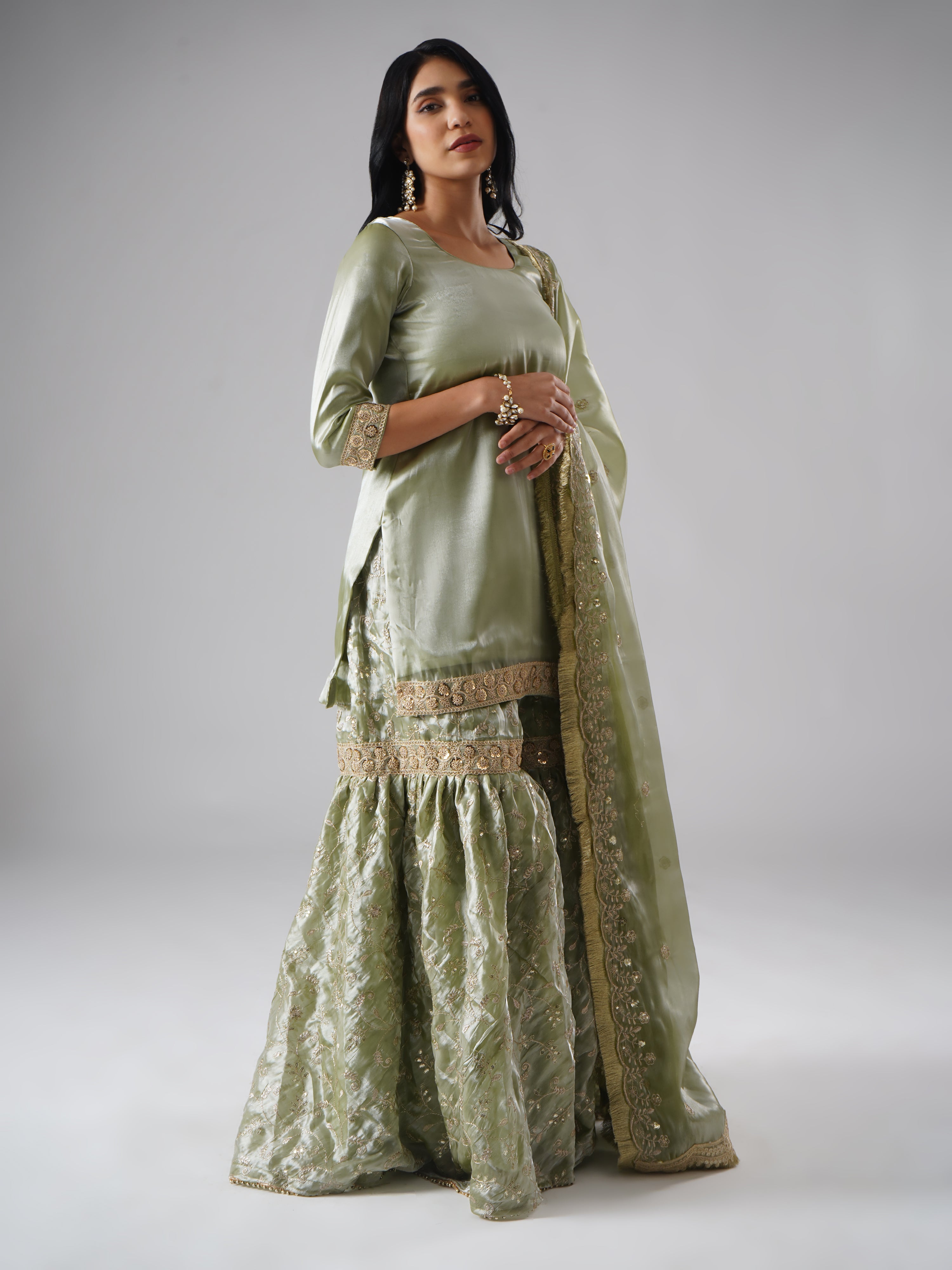 Right side view of model wearing Zahrat’s Mehr-e-Zaytuni – The Olive Whisper gharara set, showcasing the draped dupatta along with the complete ensemble.