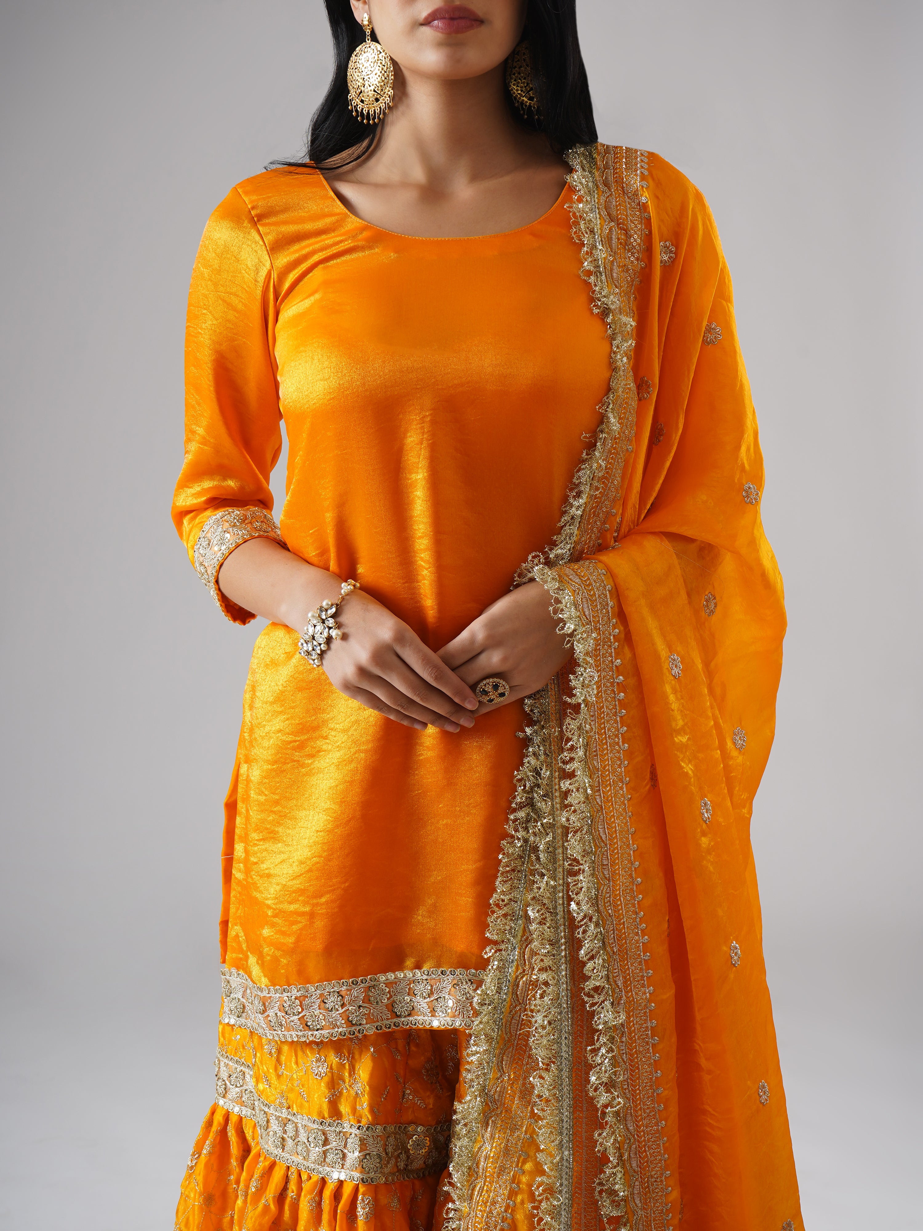 Close-up of the Mehrigold gharara set by Zahrat, highlighting intricate embroidery and fabric detailing.