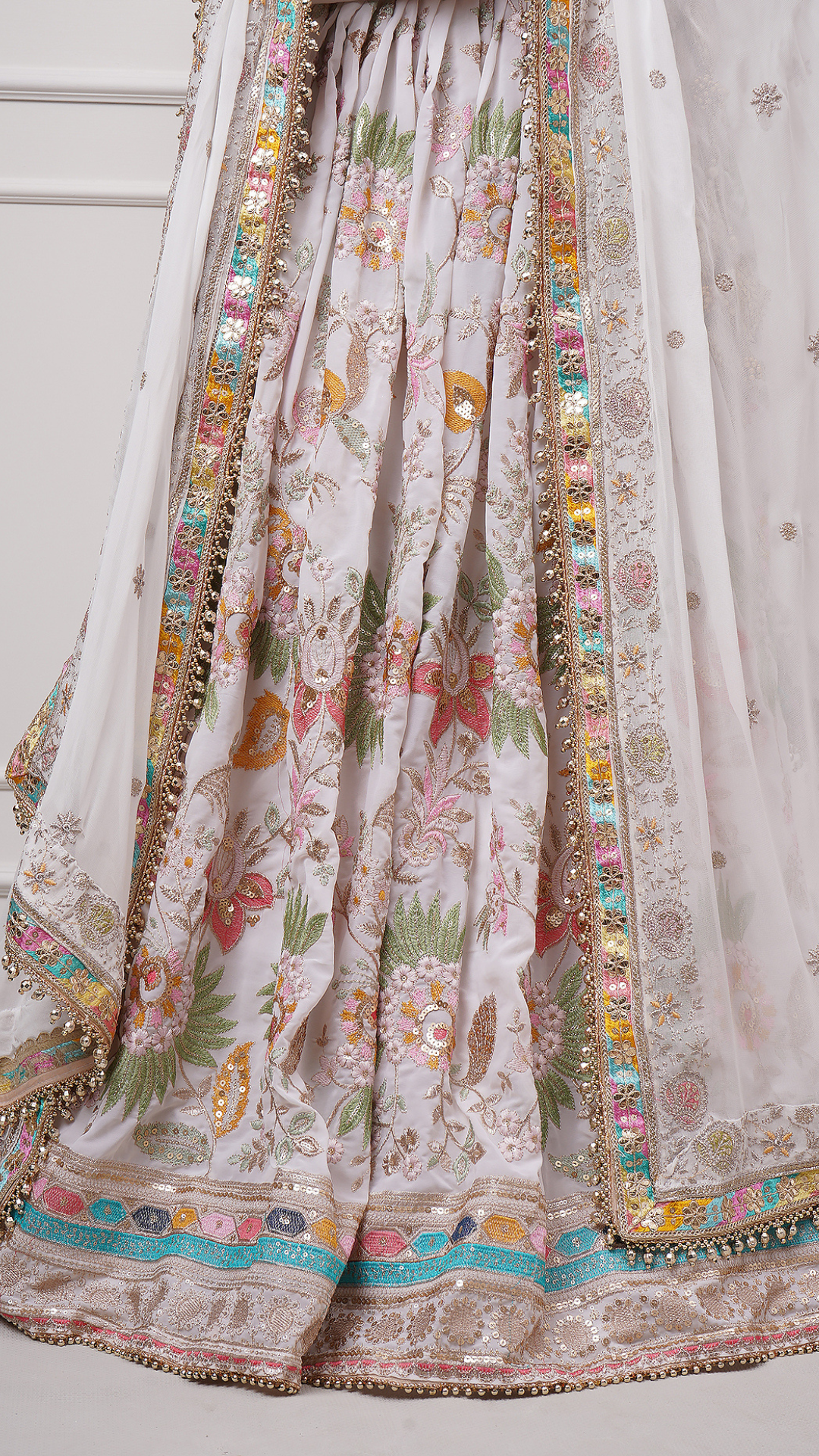 A close-up of Eira Bloom Lehenga Set - Zahrat White Embroidered Lehenga highlighting the lehenga flare and embroidery.