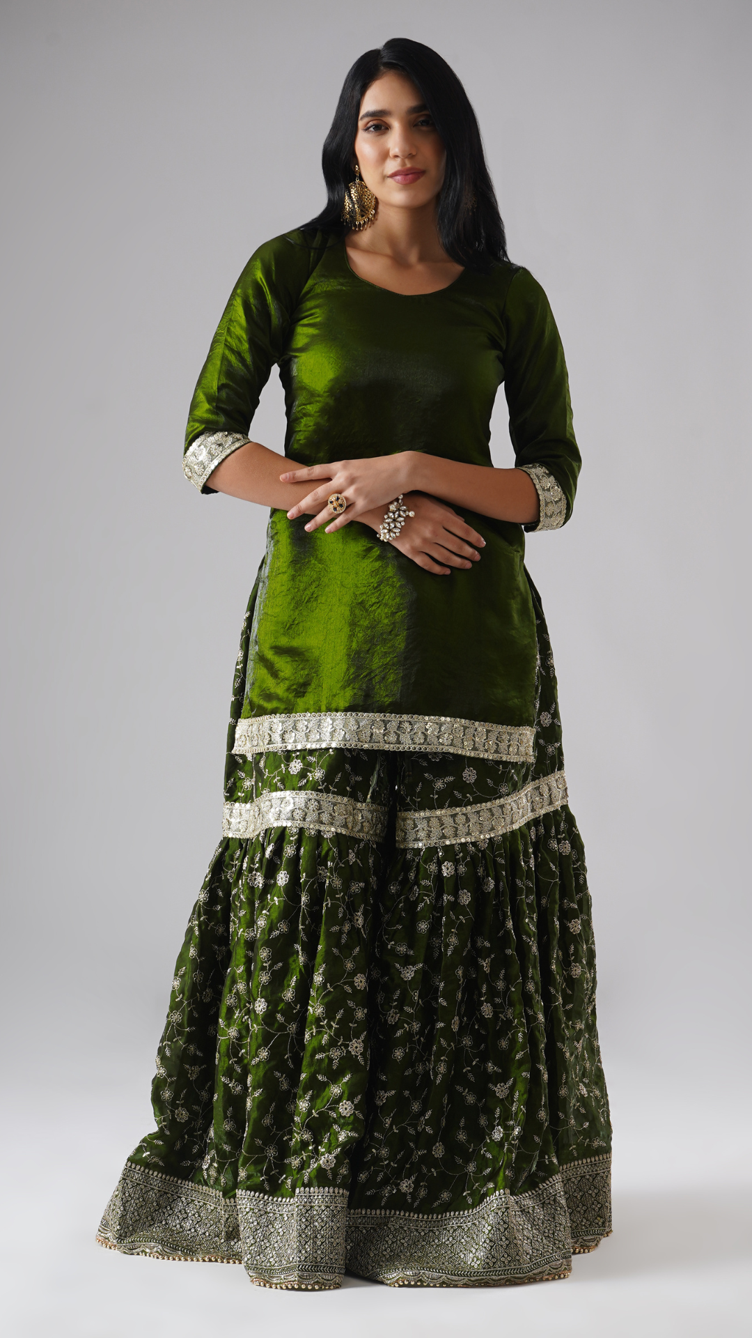 Front view of model wearing Zahrat’s Khushrang Henna jewel-toned henna green gharara set, showcasing the gharara and kurta without the dupatta.