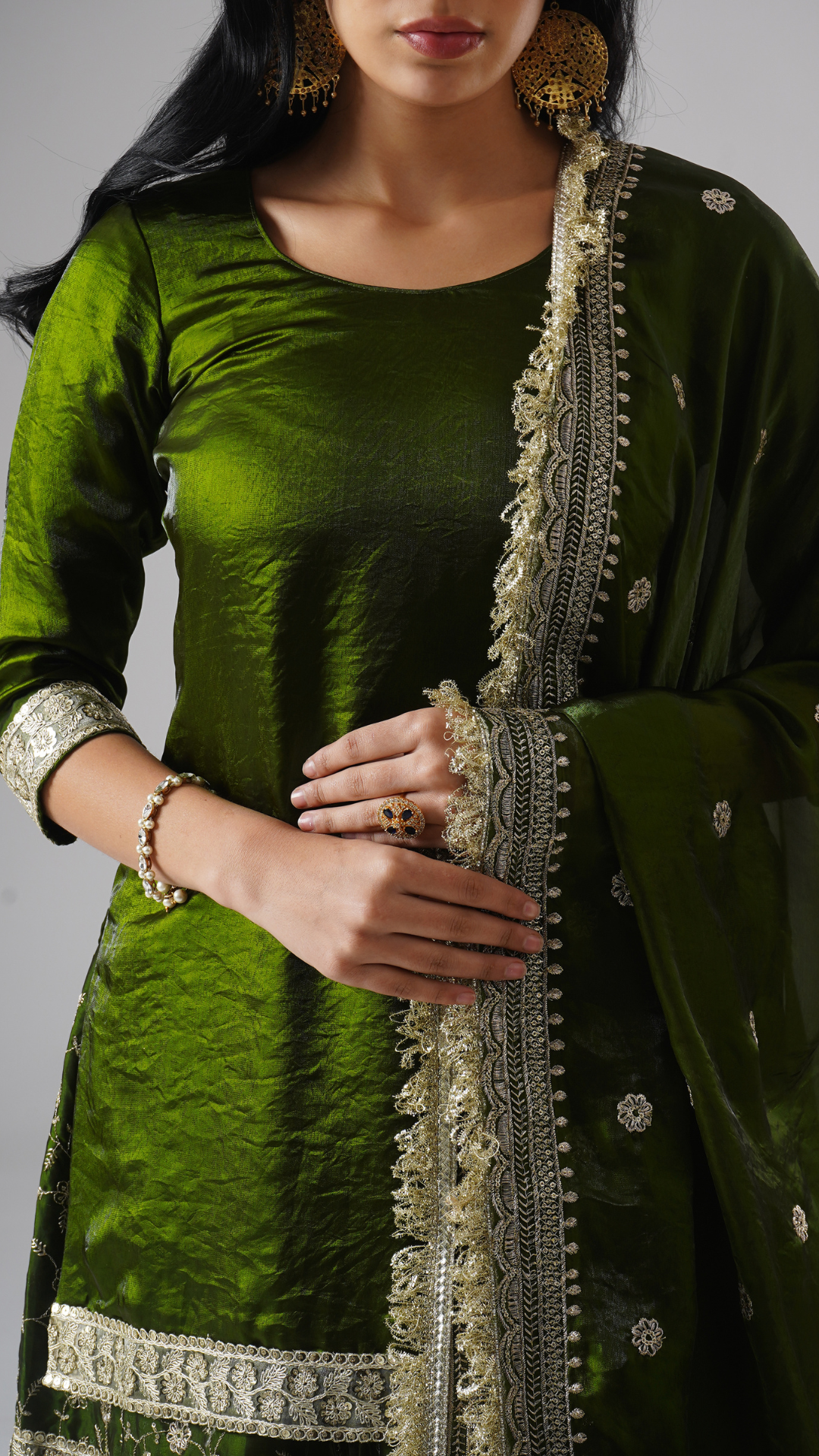 Khushrang Henna jewel-toned henna green gharara set by Zahrat, close-up highlighting kurta fabric and dupatta embroidery details.