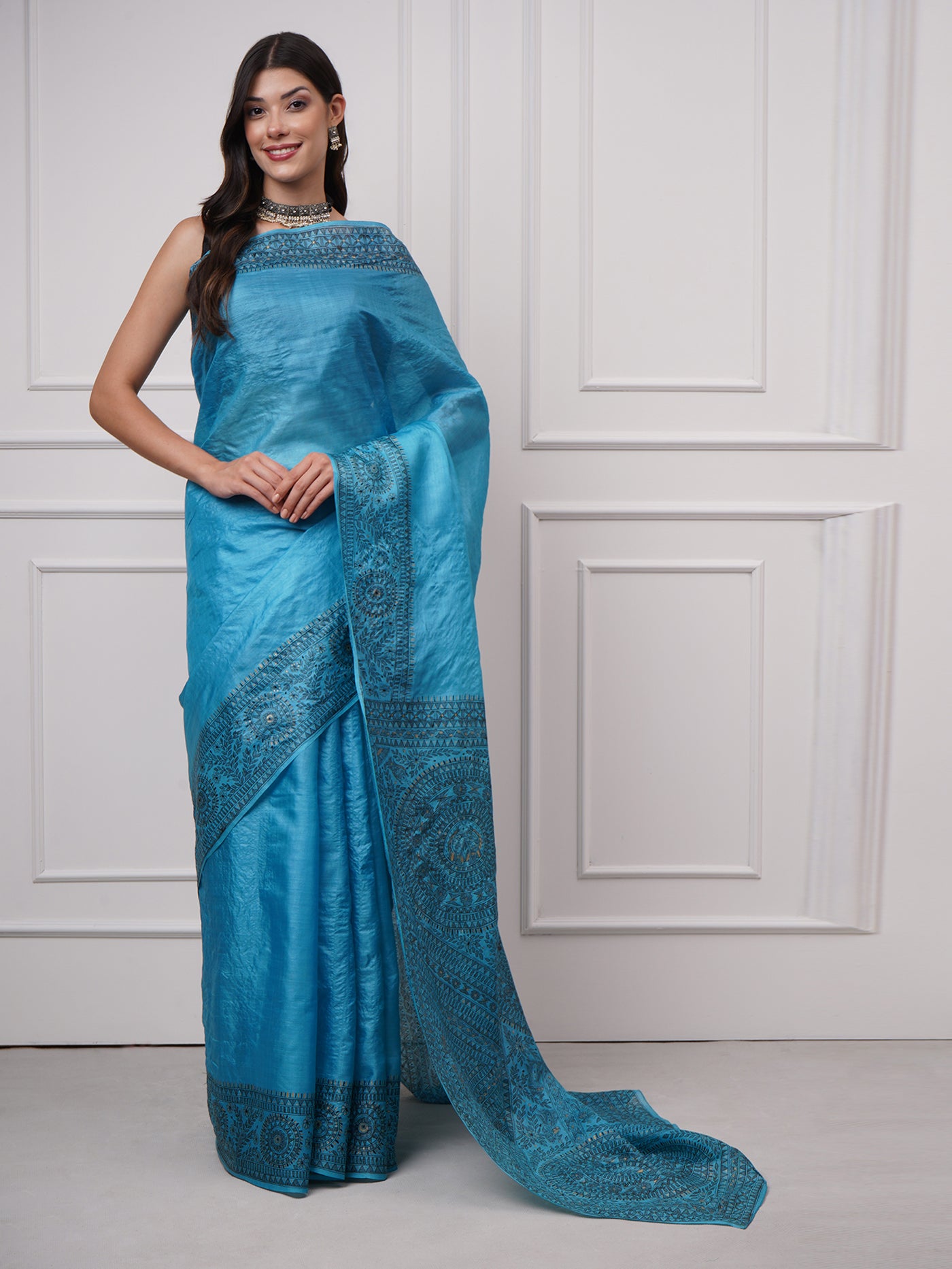Model wearing Neelambara – Azure Madhubani Silk Saree by Zahrat with an elegant front drape showcasing hand-painted fish and geometric motifs.