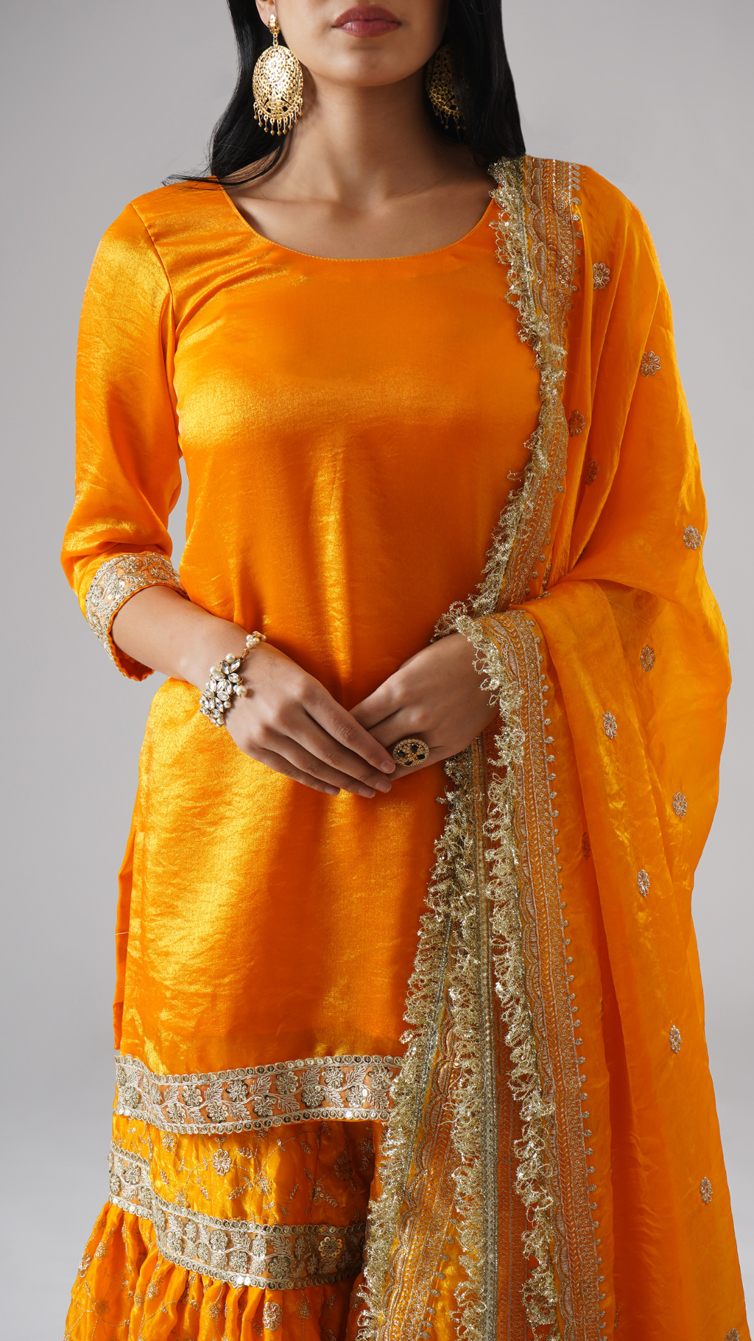 Close-up of the Mehrigold gharara set by Zahrat, highlighting intricate embroidery and fabric detailing.
