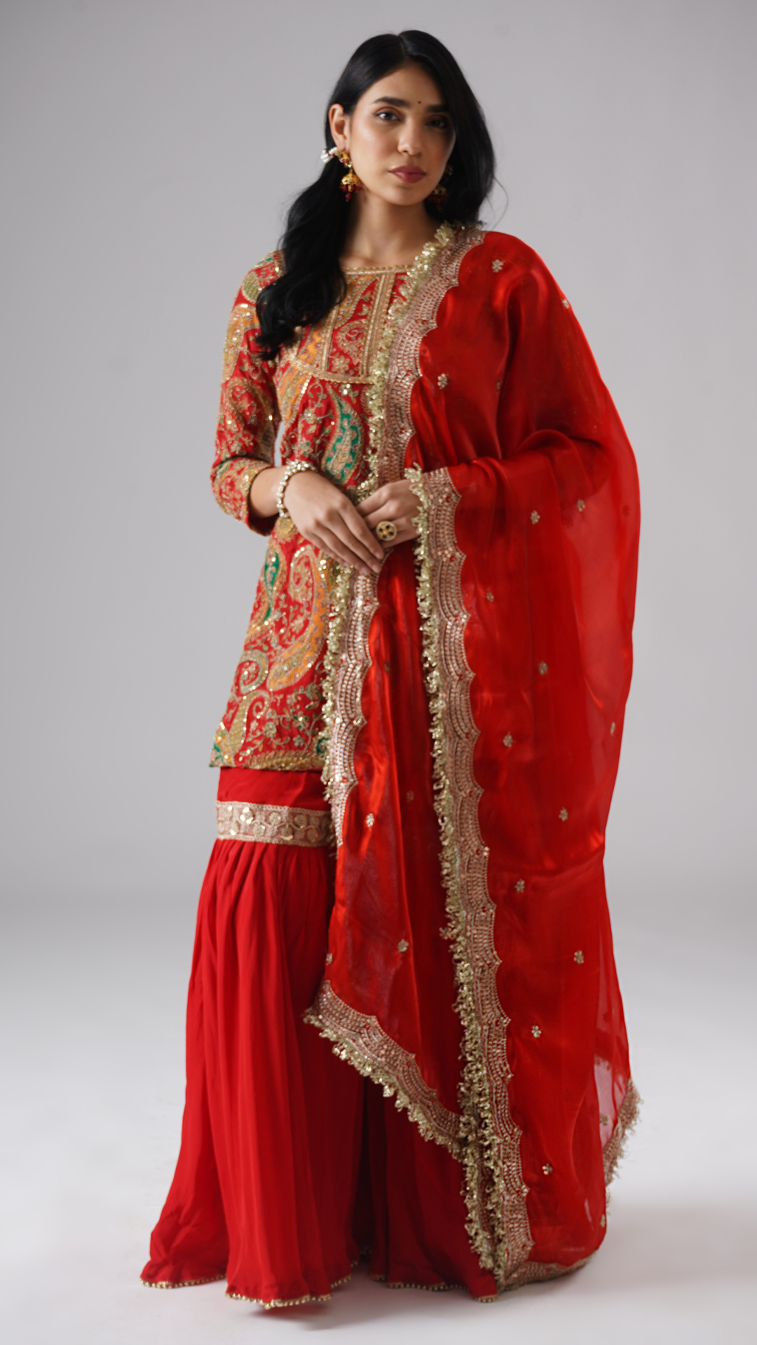 Front view of Mehroza crimson red gharara with dupatta styled to the side, showcasing the complete set.