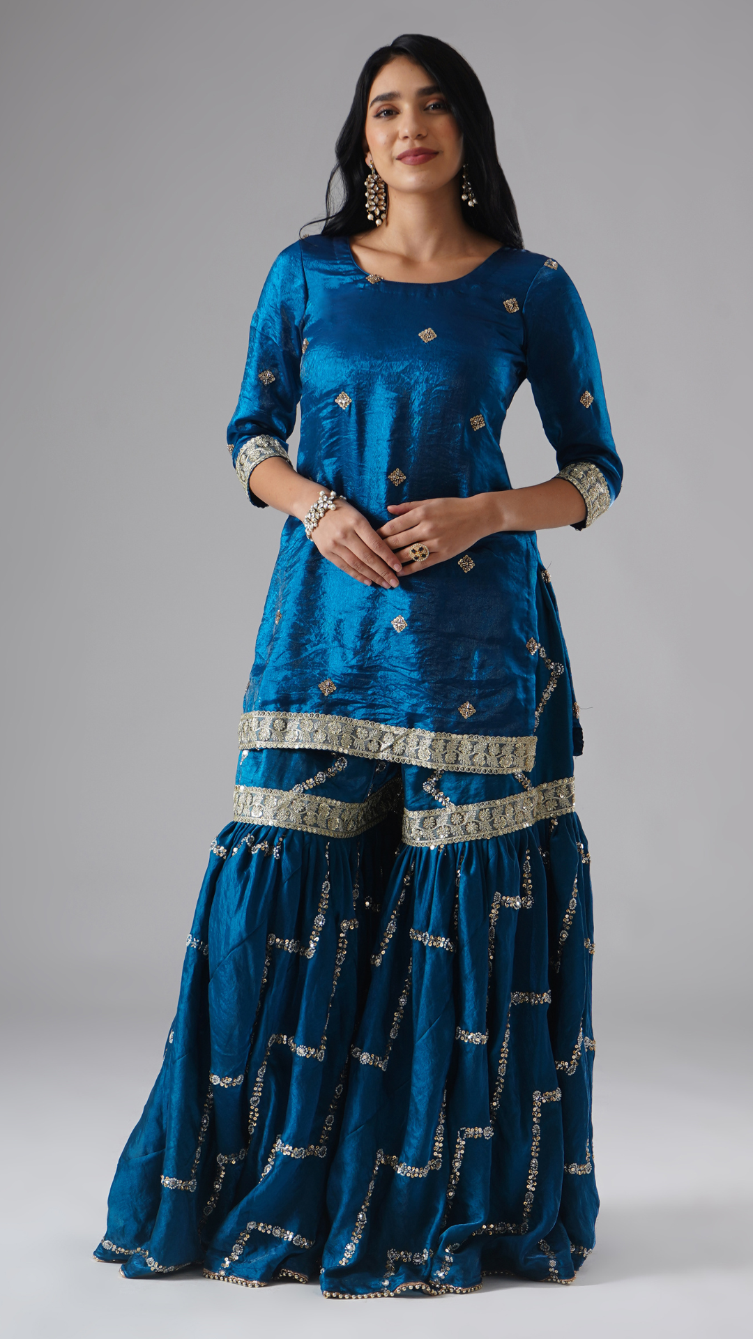 Model styled in the Neelafshan – The Teal Sapphire gharara set by Zahrat, front view highlighting the gharara and kurta without dupatta.