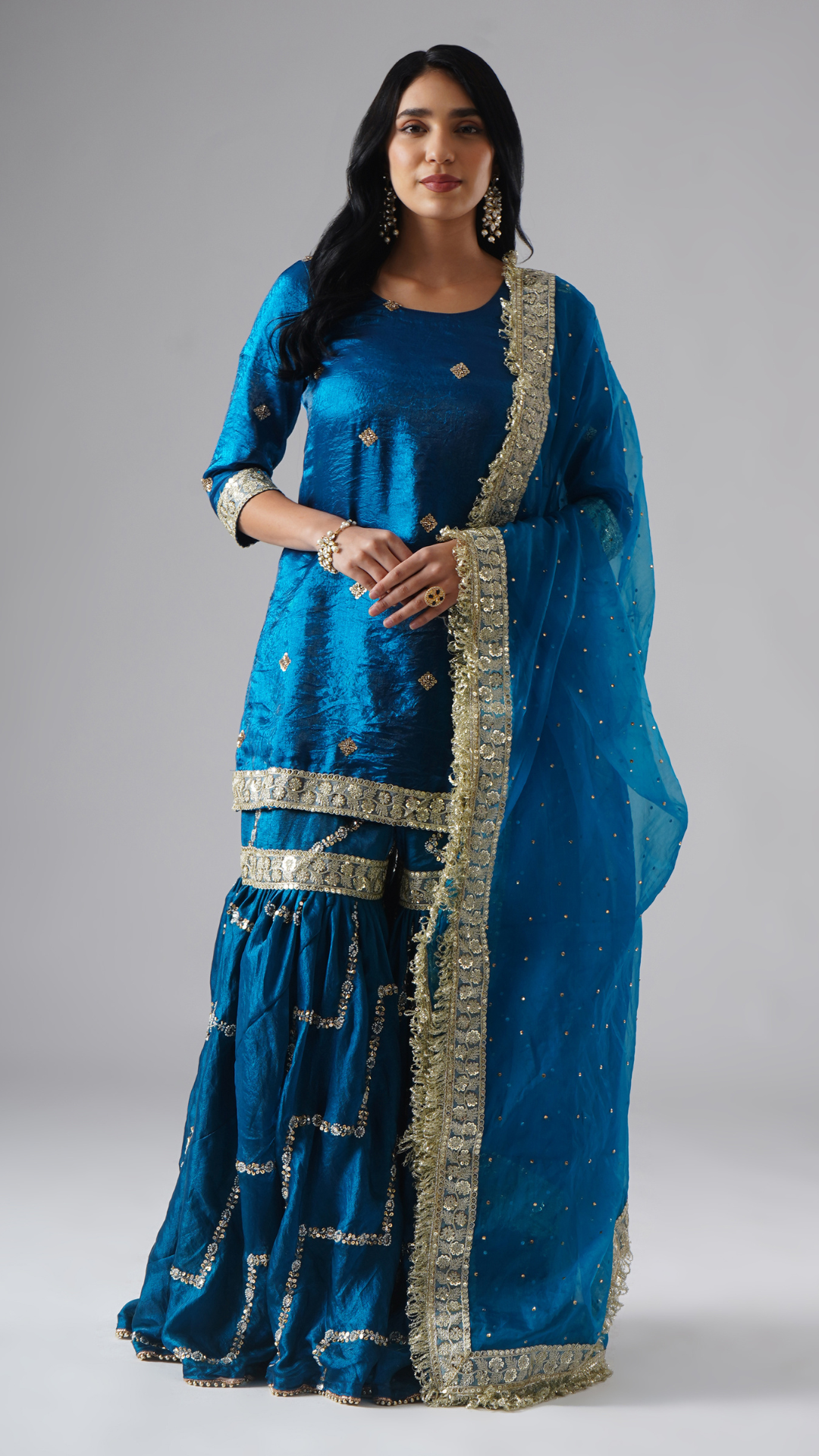 Neelafshan – The Teal Sapphire gharara set by Zahrat worn by model, front view featuring the complete ensemble with dupatta.