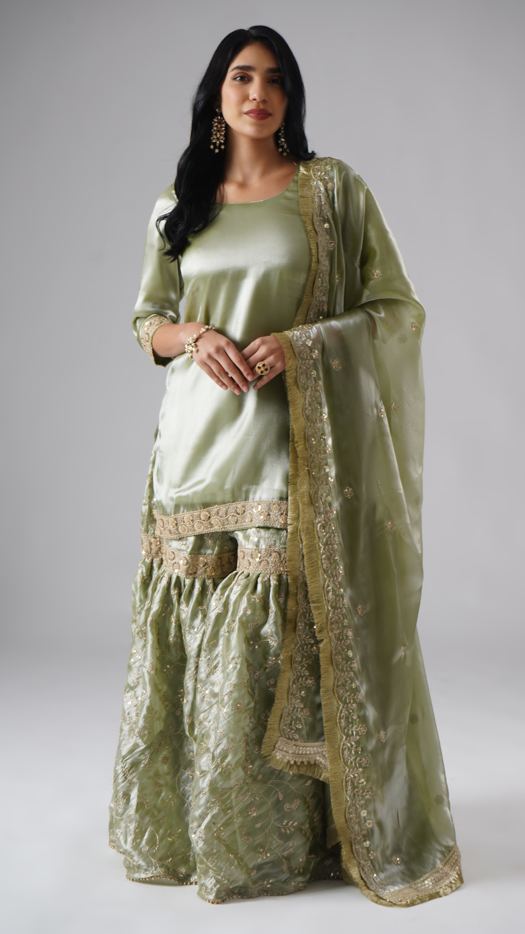 Model styled in the Mehr-e-Zaytuni – The Olive Whisper gharara set by Zahrat, front view highlighting the full outfit including gharara, kurta, and dupatta.