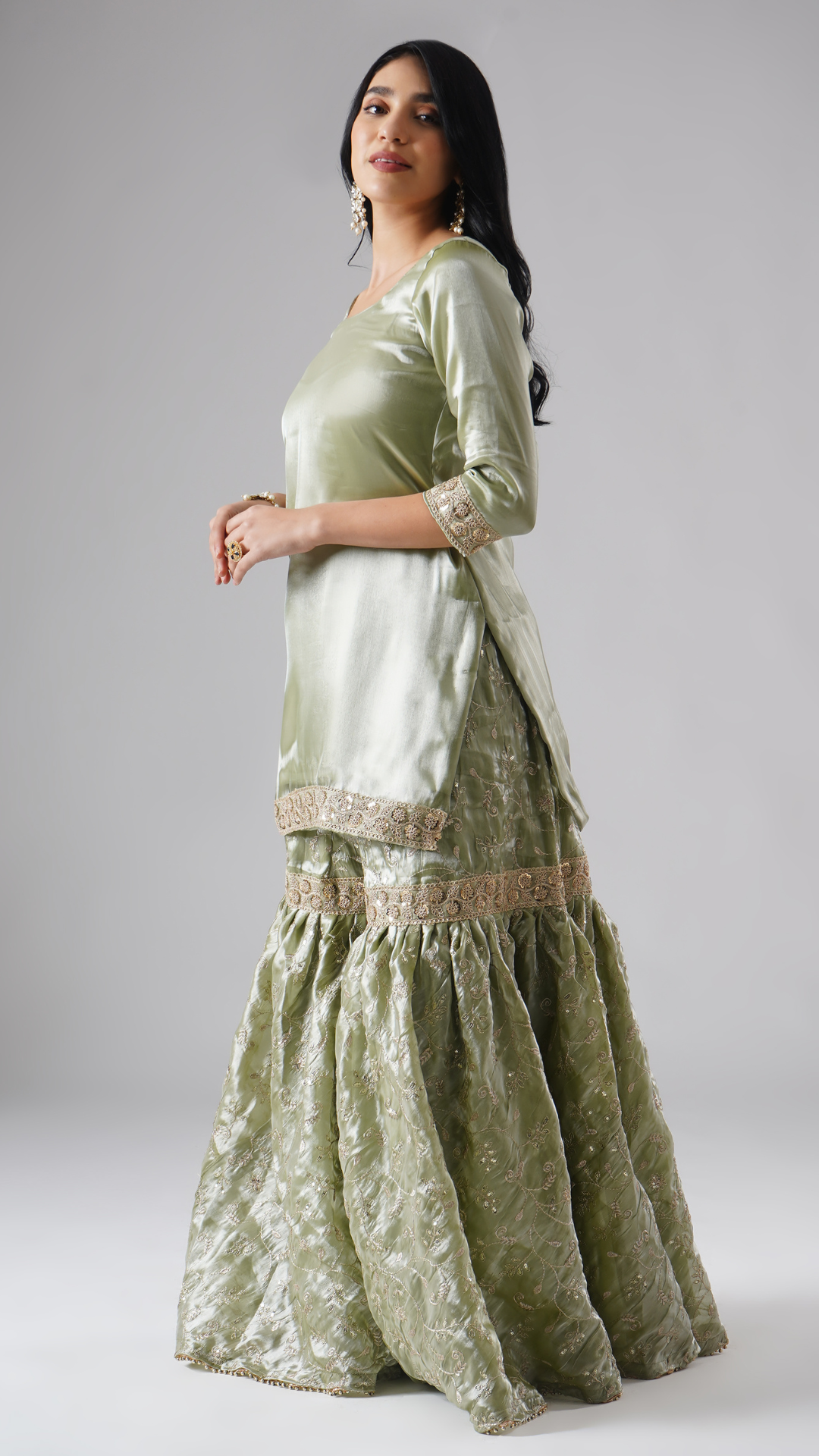 Side view of model wearing Zahrat’s Mehr-e-Zaytuni – The Olive Whisper gharara set without dupatta, highlighting the gharara flare and kurta.