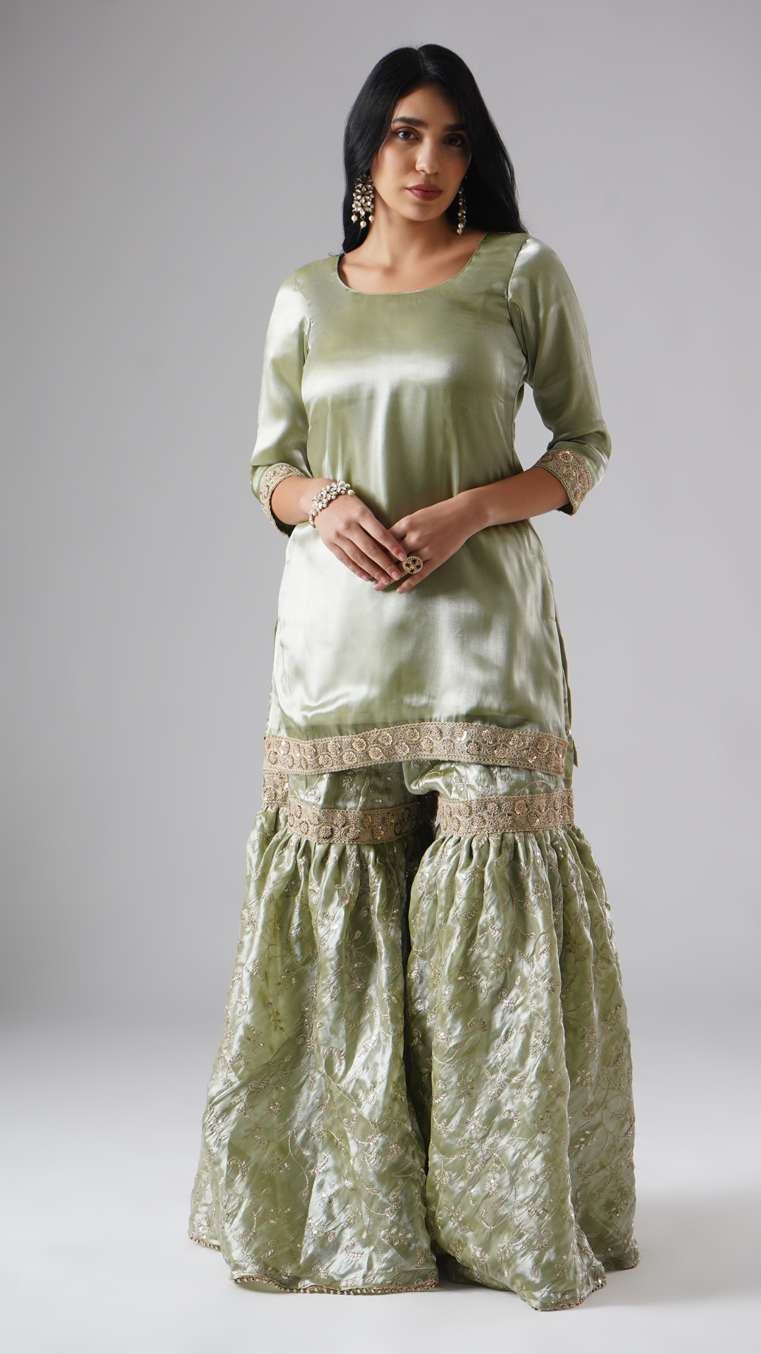 Model styled in the Mehr-e-Zaytuni – The Olive Whisper gharara set by Zahrat, front view highlighting the gharara and kurta without dupatta.