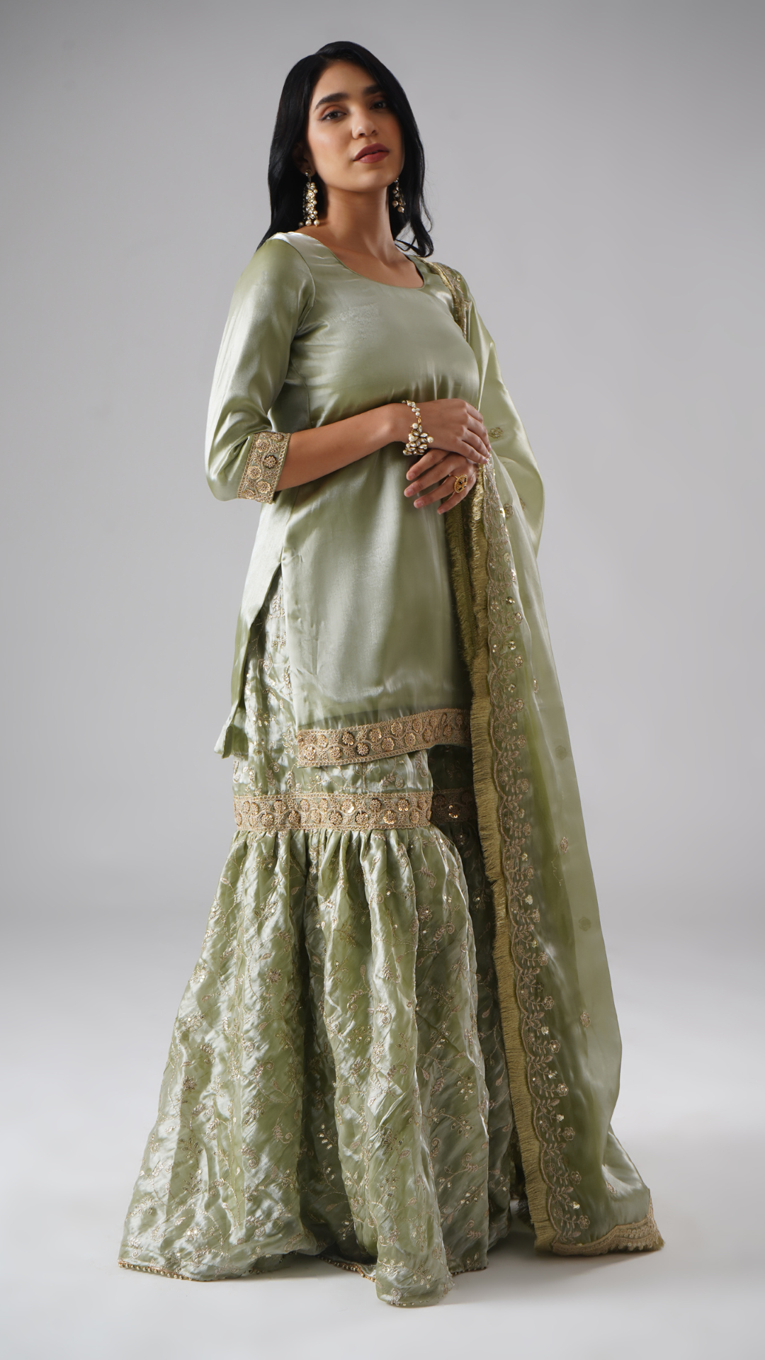 Right side view of model wearing Zahrat’s Mehr-e-Zaytuni – The Olive Whisper gharara set, showcasing the draped dupatta along with the complete ensemble.