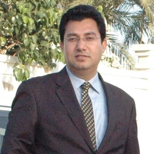 Syed Misbauddin, Founder of Zahrat, smiling confidently in formal attire, representing integrity, elegance, and the vision behind the brand.