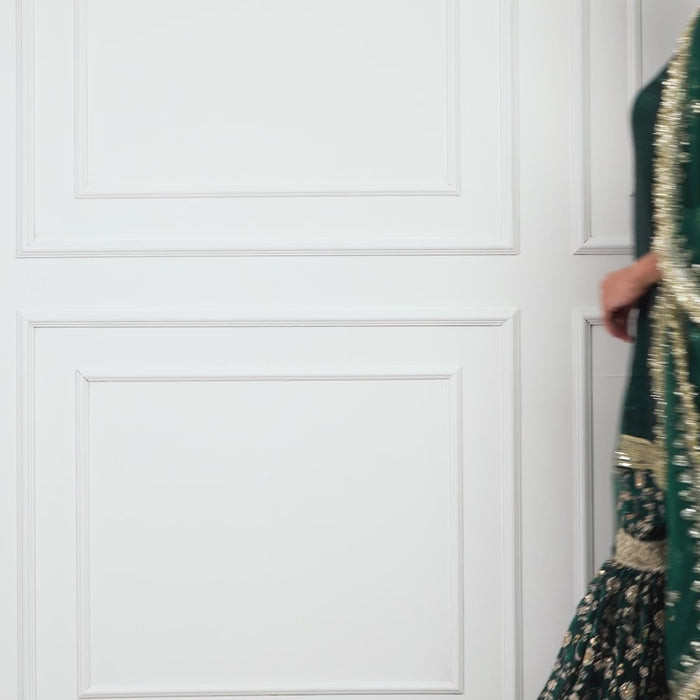 Video of model in Zahrat Zyra – Regal Ivy Gharara Set, twirling to reveal bottle-green flare, gold embroidery, and shimmering dupatta.