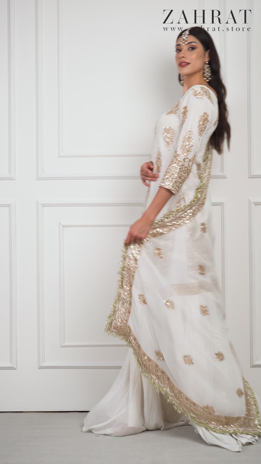 A model wearing Naoura withe and gold Gharara by Zahrat