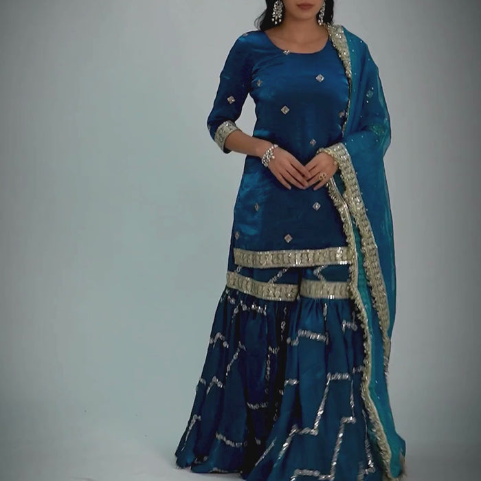 Neelafshan Teal Sapphire Gharara – modern teal wedding gharara set with flared pants, sleek embroidered kurta, and lightweight embellished dupatta, perfect for festive and wedding occasions.