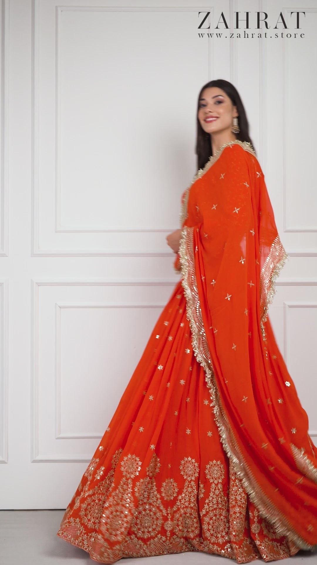 Model gracefully walking and twirling in the Amber Dusk embroidered lehenga by Zahrat, showcasing the lehenga's flow, detailed embroidery, and elegant drape of the dupatta