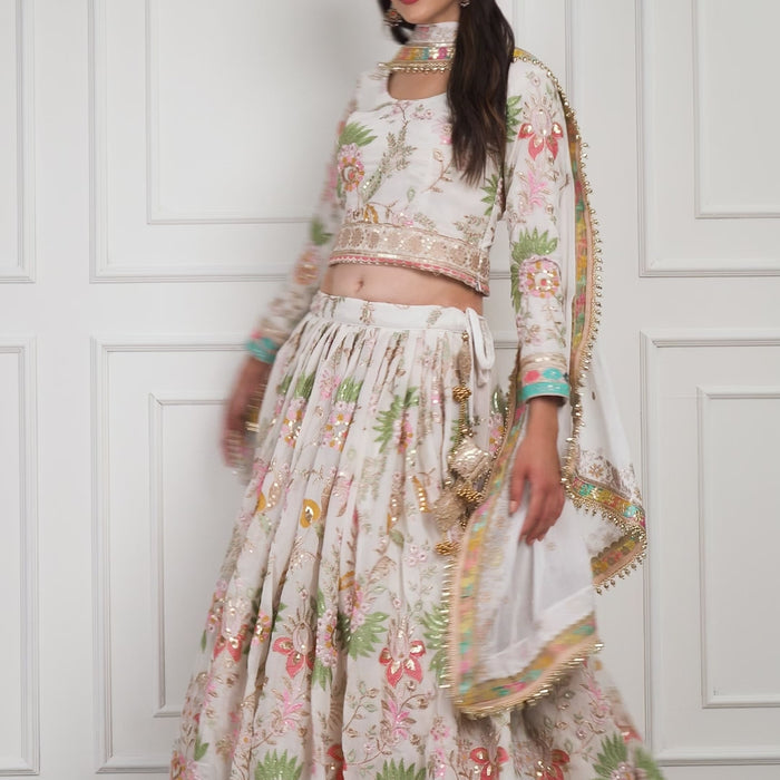Model gracefully twirling in the Eira Bloom lehenga, revealing the soft flow of the fabric and pastel floral embroidery in motion