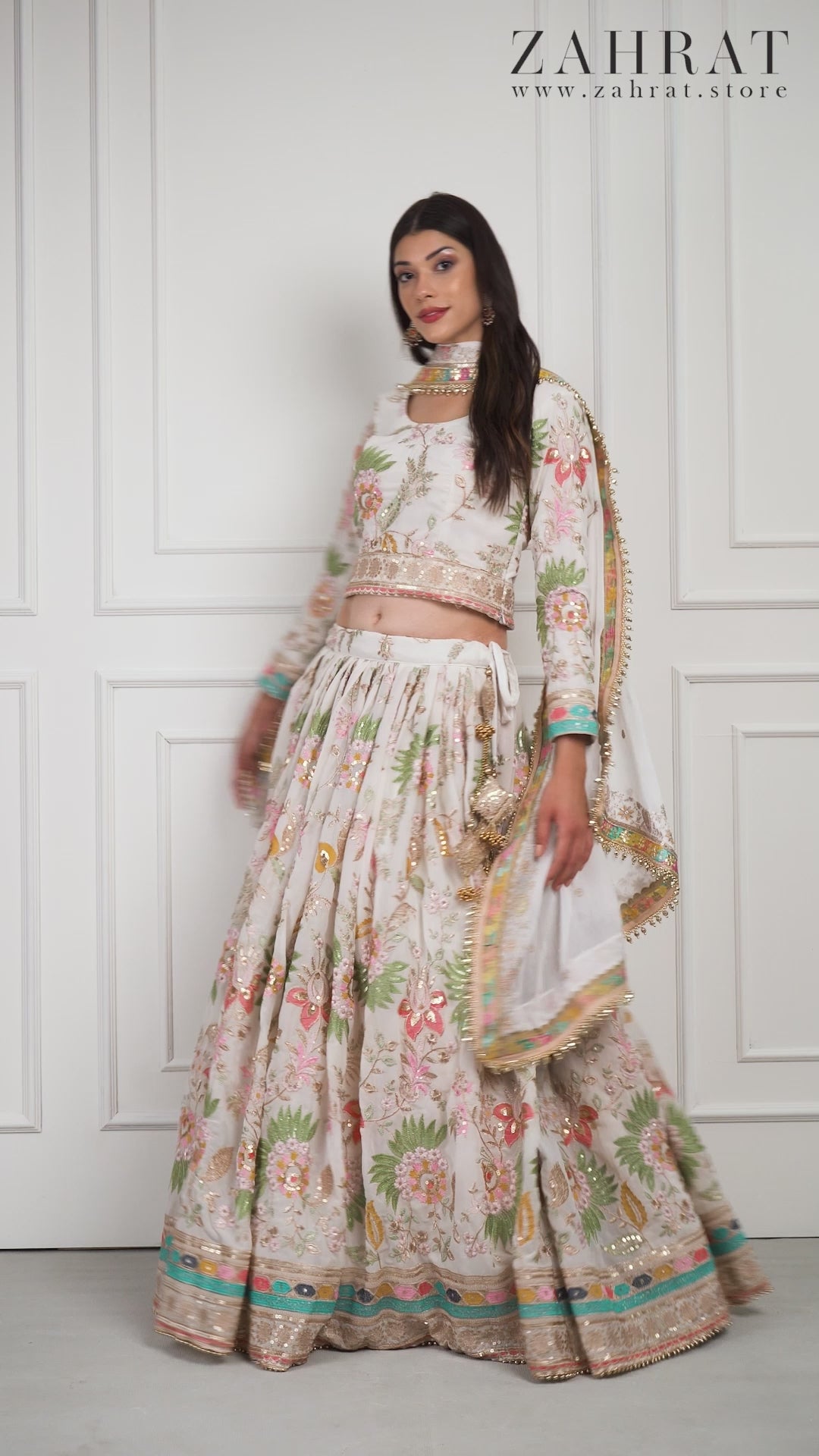 Model gracefully twirling in the Eira Bloom lehenga, revealing the soft flow of the fabric and pastel floral embroidery in motion