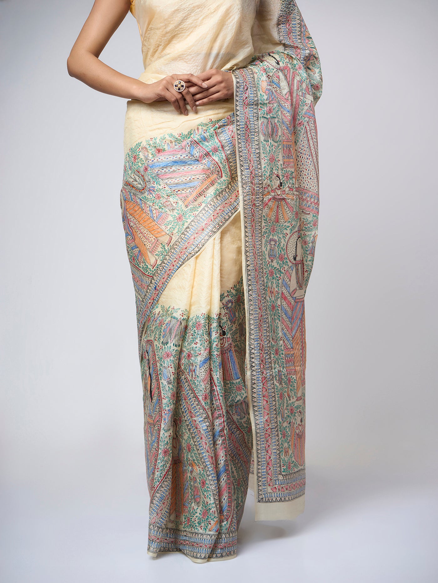Close-up view of Varnika Sand Ivory Madhubani silk saree highlighting the intricate hand-painted Mithila artwork, fine detailing, and rich artisanal texture on pure silk.