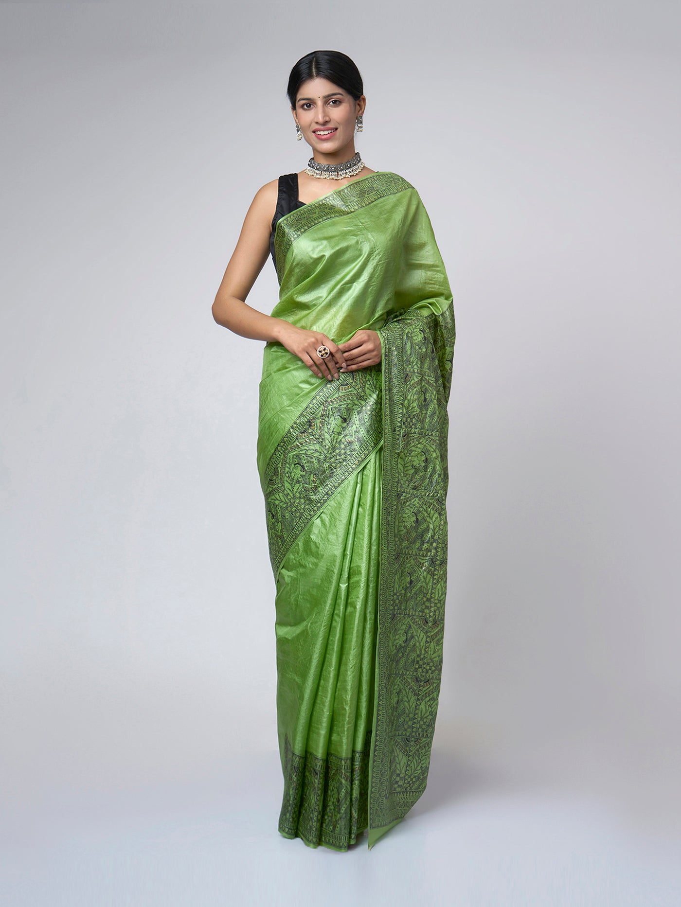 Model wearing Naqsh-e-Zumurrud emerald Madhubani Tussar silk saree with elegant front drape and intricate hand-painted heritage motifs with broad artistic border.