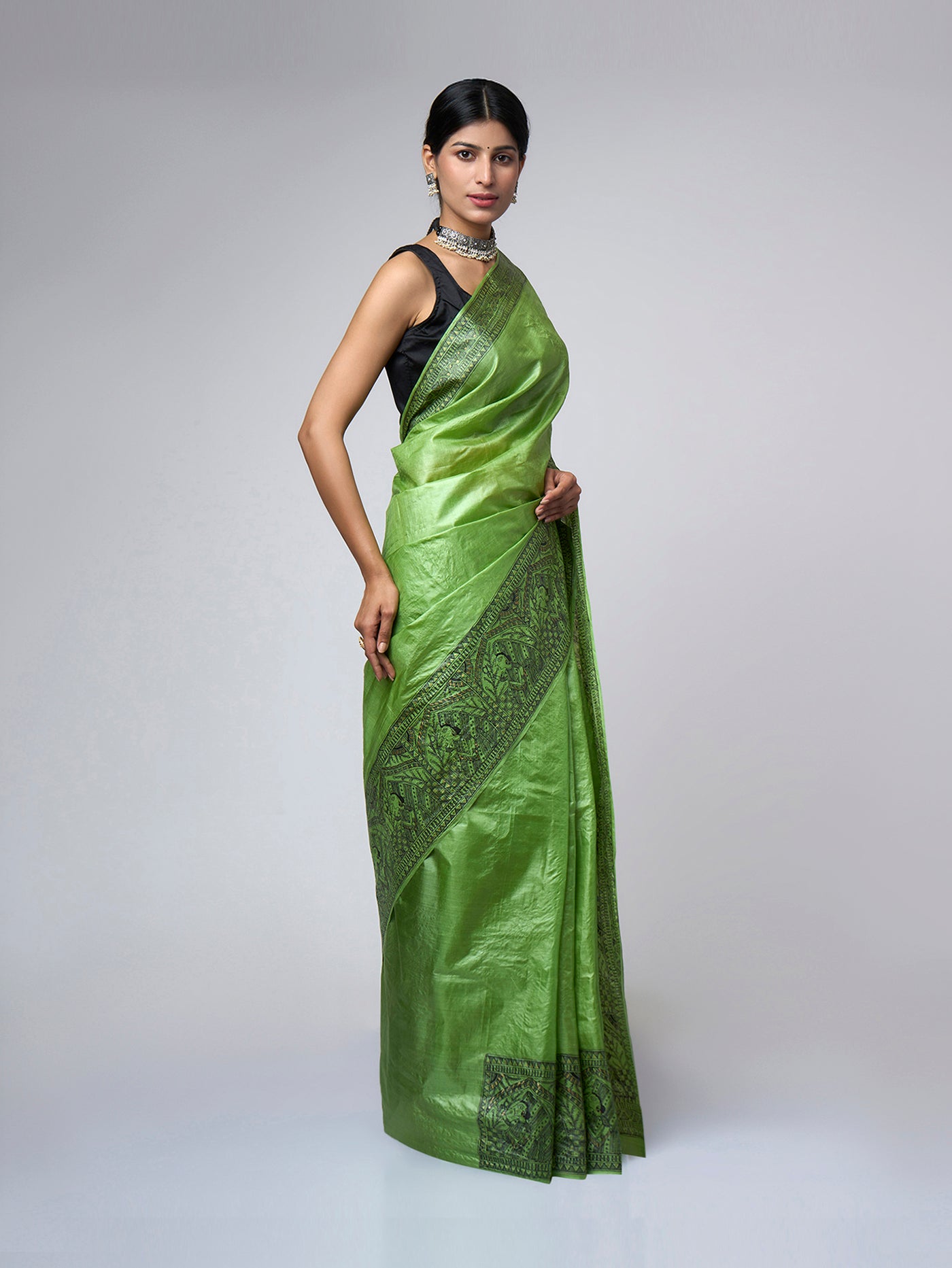 Right side view of Naqsh-e-Zumurrud hand-painted emerald Madhubani saree with detailed Mithila artwork and fluid Tussar silk drape.